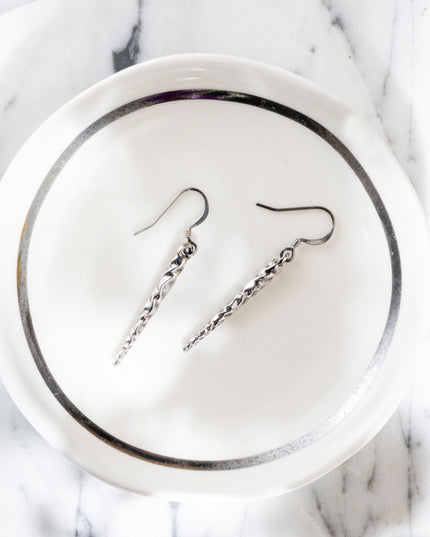 pewter icicle earrings in a white and silver catchall dish