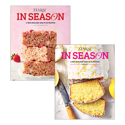 Two Yankee In Season recipe book covers are shown overlapping on a light neutral background. The front cover features a yellow lemon cake with sliced pieces, a knife, and lemon halves, with pink title text.