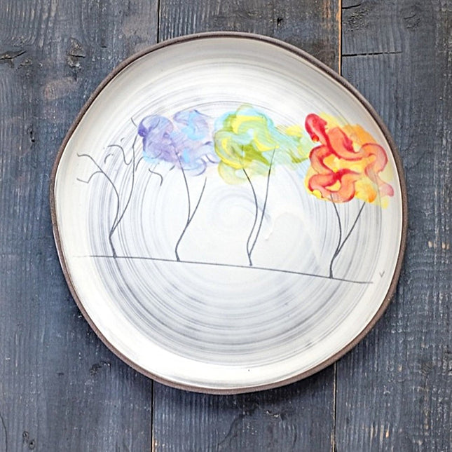 Decorative plate with tree design featuring four trees with their changing foliage through the seasons