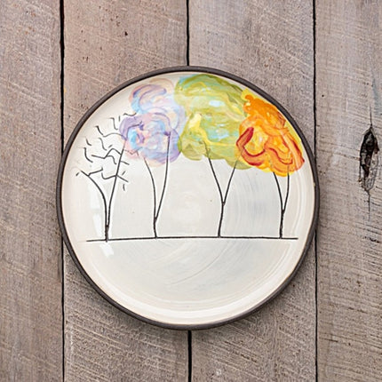 Decorative plate with tree design featuring four trees with their changing foliage through the seasons
