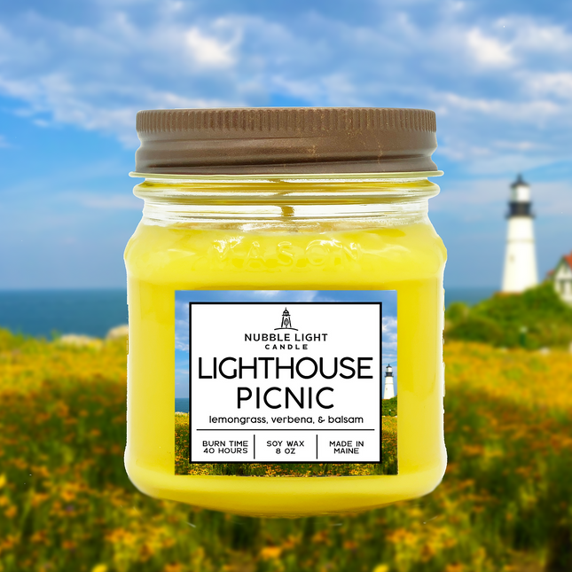 Jar of 'Lighthouse Picnic' candle with a lighthouse in the background