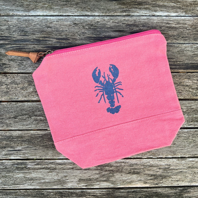 red pouch with a blue lobster design on a wooden surface