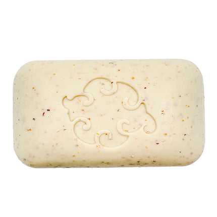a close up of the Mint Loofa soap bar showing the creamy white color of the soap dotted with bits of exfoliating seaweed