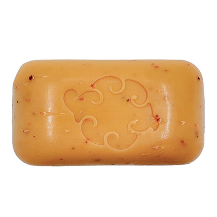 a close up of the Spice Loofa Soap showing its warm burnt orange color dotted with bits of exfoliating seaweed