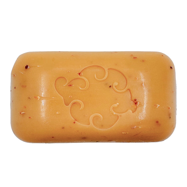 a close up of the Spice Loofa Soap showing its warm burnt orange color dotted with bits of exfoliating seaweed
