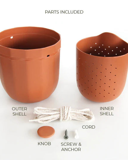 the terracotta loop planter and all of its parts and pieces: outer shell, inner shell, knob for the wall, screw and anchor, and hanging cord