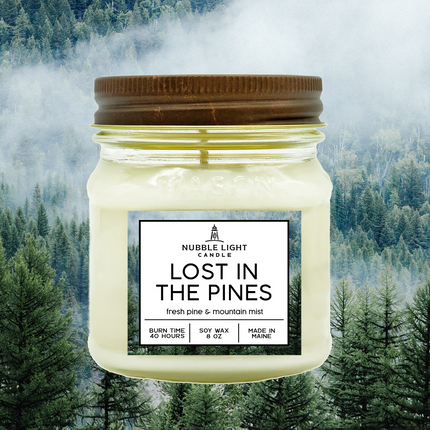 Candle jar labeled 'Lost in the Pines' with a forest background