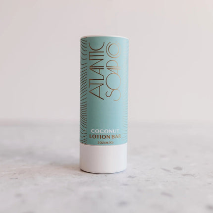 Coconut lotion bar in a cylindrical container with 'Atlantic Soap Co' branding on a light background