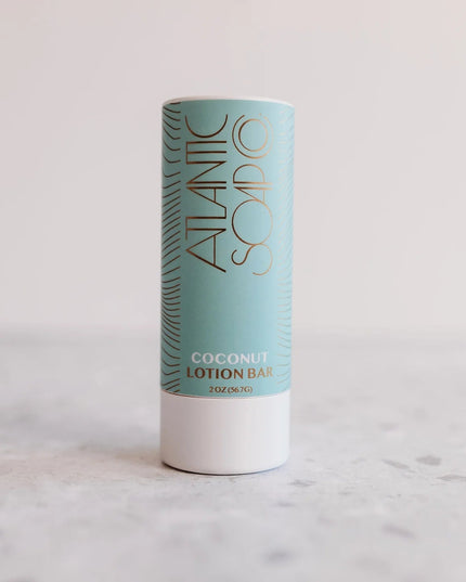 Coconut lotion bar in a cylindrical container with 'Atlantic Soap Co' branding on a light background