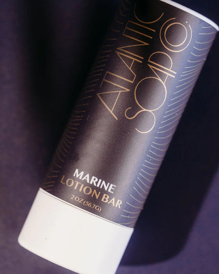 Marine Lotion Bar by Atlantic Soap on a dark purple background