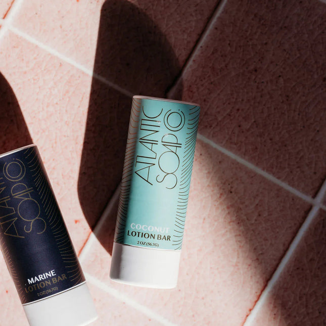 Two Atlantic Soap Co. lotion bars 
on a tiled surface
