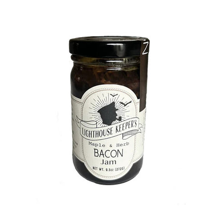 a jar of maple and herb bacon jam with a white label with a logo of a silhoutted man in a captain's hat smoking a pipe with seagulls flying behind him