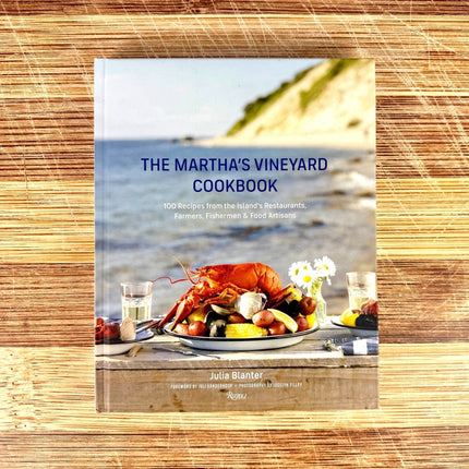 Cookbook titled 'The Martha's Vineyard Cookbook' on a wooden surface
