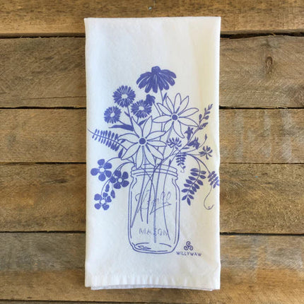 White towel with blue floral design on a wooden surface