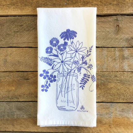 White towel with blue floral design on a wooden surface