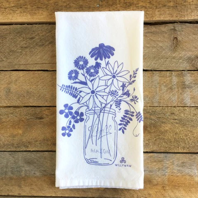 White towel with blue floral design on a wooden surface