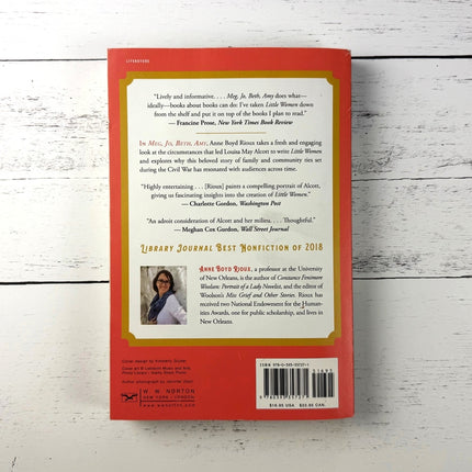 Book back cover with text and a barcode on a wooden surface