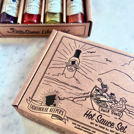 a marble countertop with the hot sauce gift set box alongside an open gift box showing the hot sauce bottles