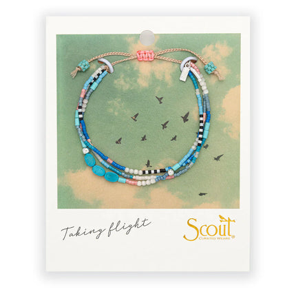 Colorful beaded bracelet on a Scout branded card that is formatted like a vintage polaroid picture with image of birds in flight