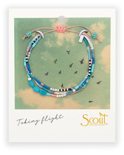 Colorful beaded bracelet on a Scout branded card that is formatted like a vintage polaroid picture with image of birds in flight