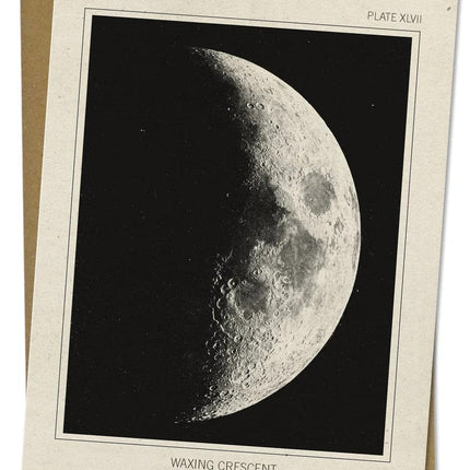 a close up look of the details of an off white greeting card with a vintage image of the moon in its waxing crescent phase