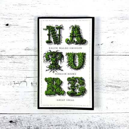 Ralph Waldo Emerson's Nature on a white wood surface
