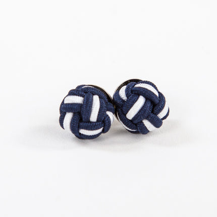 navy blue and white monkey fist knot earrings on a white background