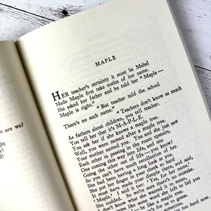 Open book with text on a wooden surface