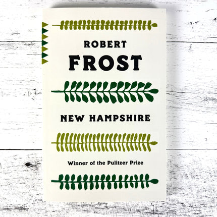 Book titled 'Robert Frost New Hampshire' with text and decorative elements on a white background