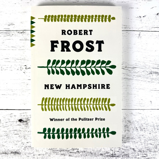 Book titled 'Robert Frost New Hampshire' with text and decorative elements on a white background