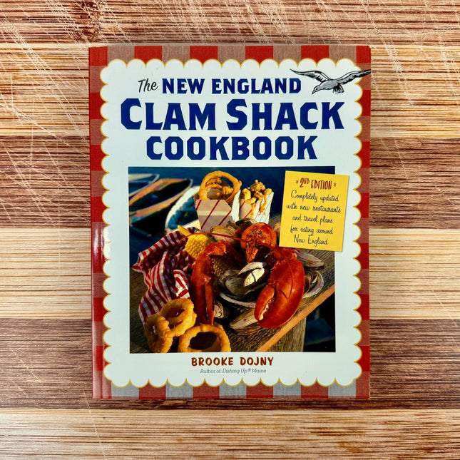 Cookbook titled 'The New England Clam Shack Cookbook' on a wooden surface