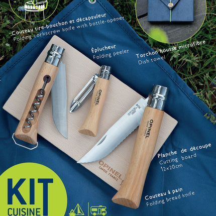 The Nomad Cooking kit with items laid out on the cutting board on top of the cloth on the grass 