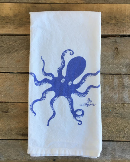 White towel with blue octopus design on a wooden surface