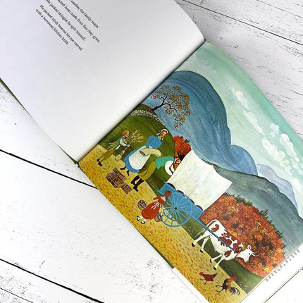 Illustration of a couple with a cart and cow in a scenic landscape on an open book.