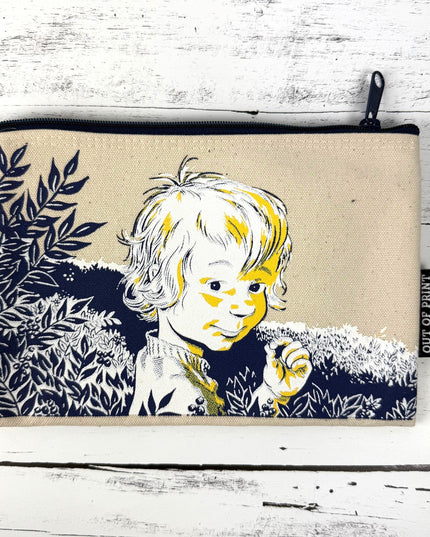 Canvas pouch with a printed design of a child and nature on a white wooden surface