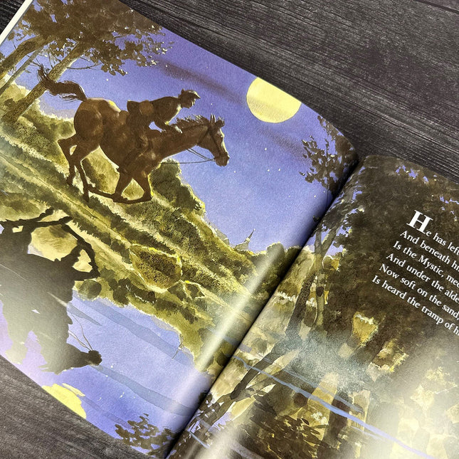 Book open to a page with a horse and rider illustration under a moonlit sky.