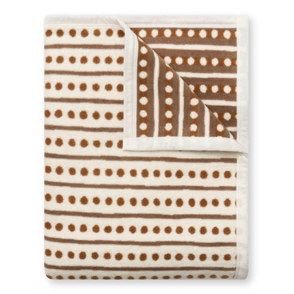 Blanket with brown polka dot and stripe pattern on a white background