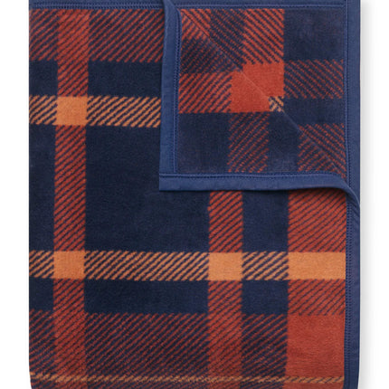 A folded Sebago Tartan blanket with the top right corner folded over to show the reverse of the design