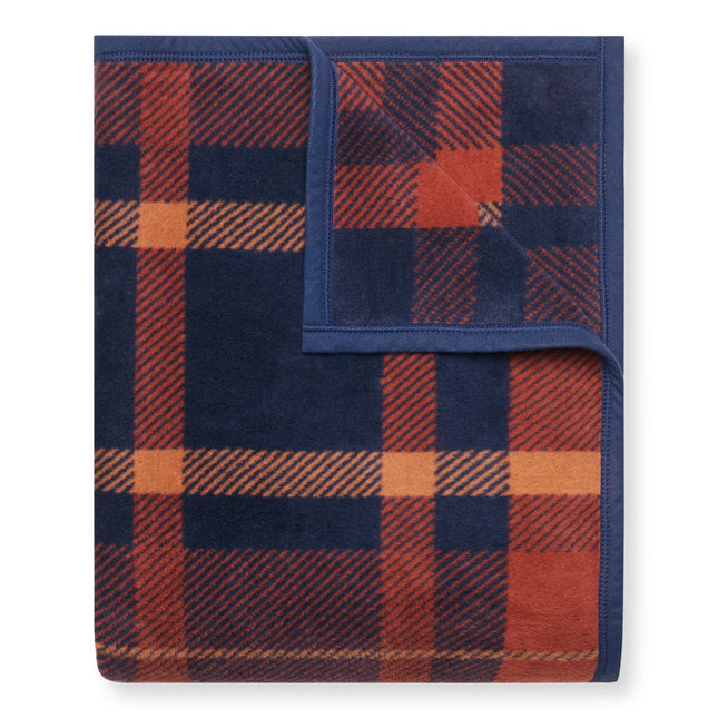 A folded Sebago Tartan blanket with the top right corner folded over to show the reverse of the design