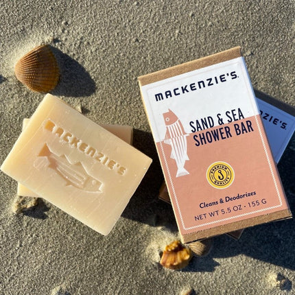 a bar of the sand and sea shower bar on a sandy beach next to the sand and sea shower bar box