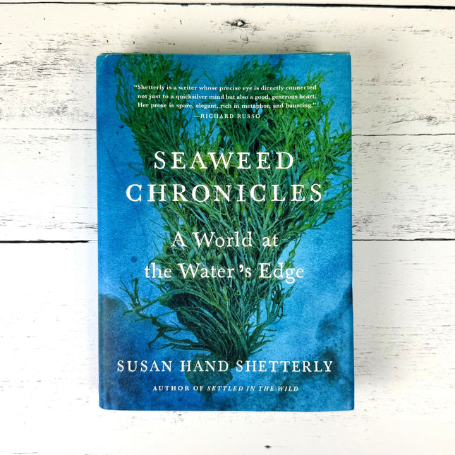 Book cover of 'Seaweed Chronicles' by Susan Hand Shetterly on a wooden surface