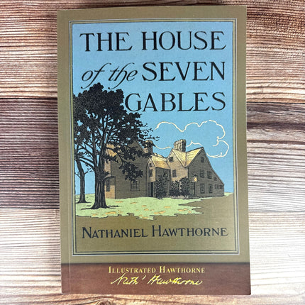 House of the Seven Gables book against a rustic wood background