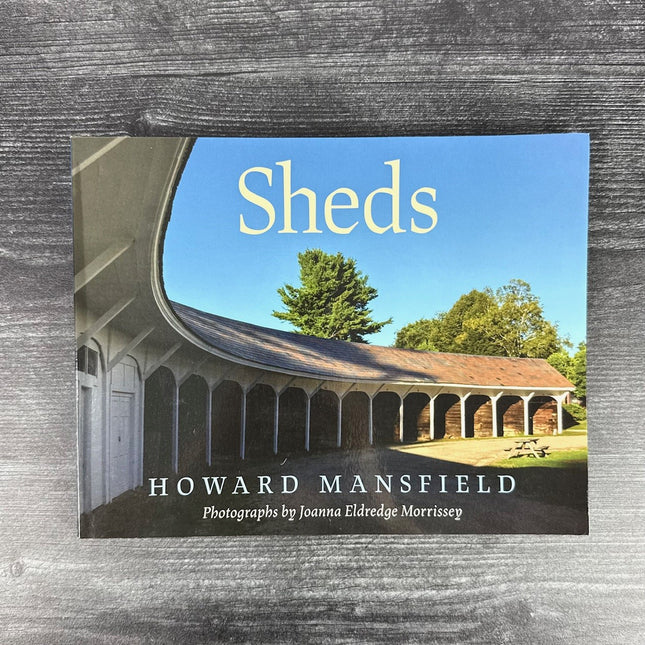 Book cover of 'Sheds' by Howard Mansfield on a wooden surface