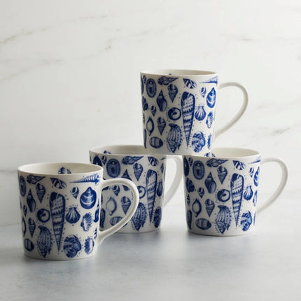 Four mugs with blue shell pattern on a light gray background