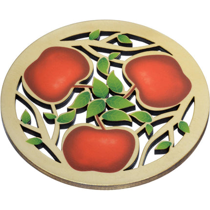 a round trivet with laser cut apple and branch design with red painted apples and green leaves