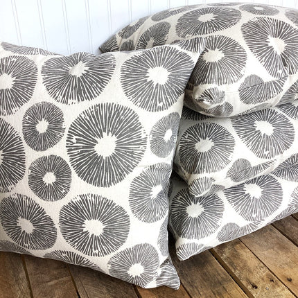 Patterned pillows on a wooden floor