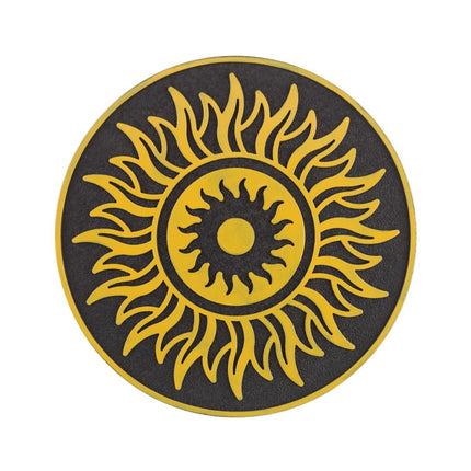 A circular black and yellow sun emblem with a textured background, isolated on a white backdrop.