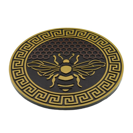 garden stepping stone with bee design and honeycomb background in yellow and brown shown at a slight angle