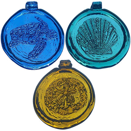 Three round blue, yellow, and turquoise glass pendants with engraved designs on a white background.