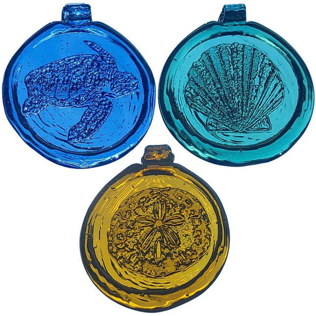 Three round blue, yellow, and turquoise glass pendants with engraved designs on a white background.